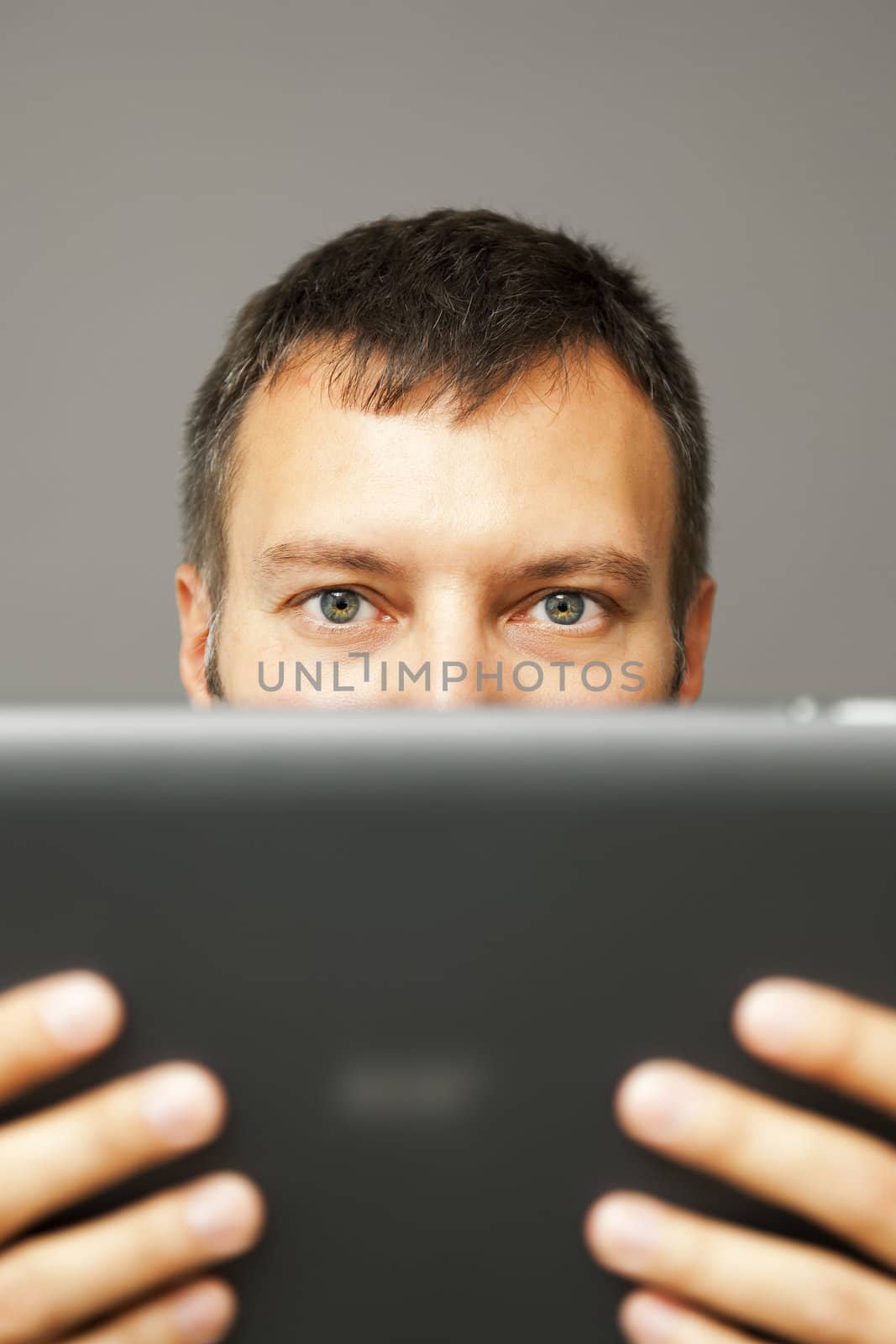 An image of a handsome business man reading his tablet pc