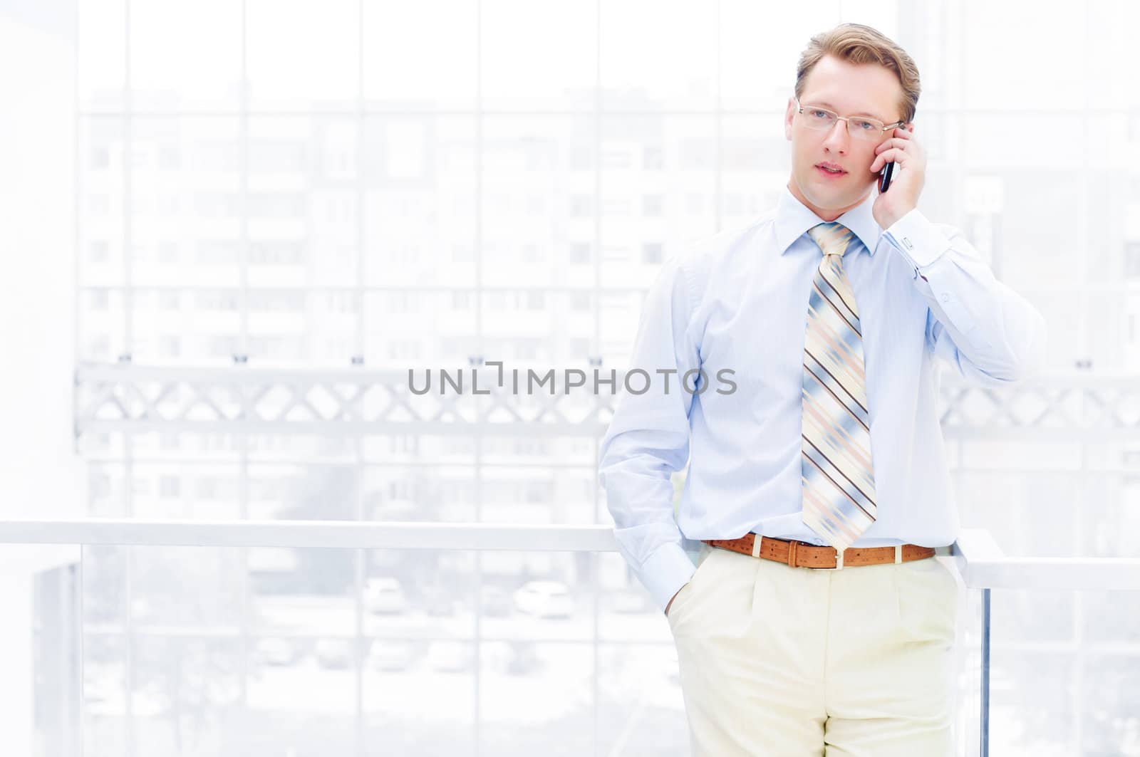 Smiling business man, talking on cell phone