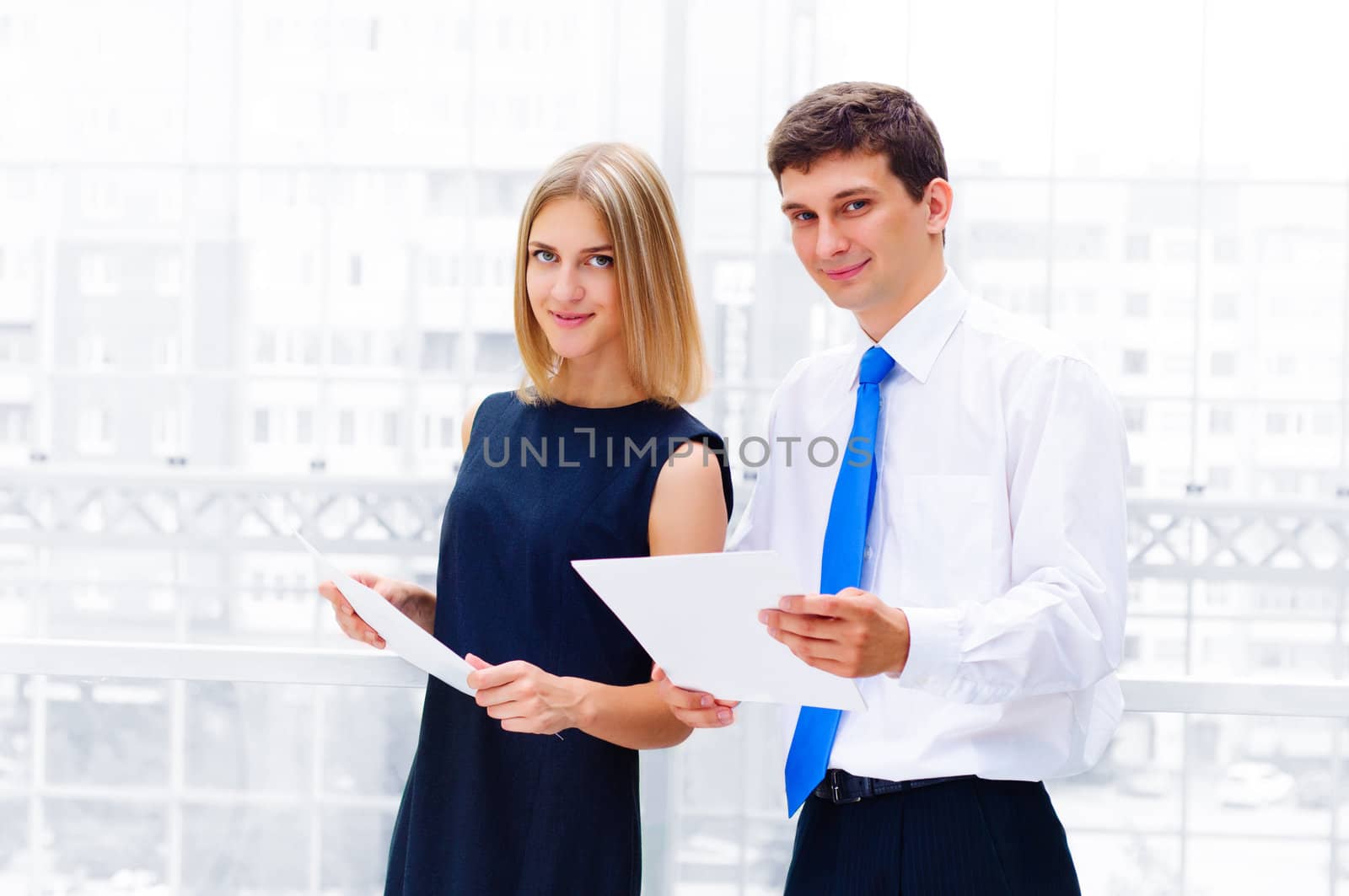 business man and business woman in the office to discuss reports by adam121