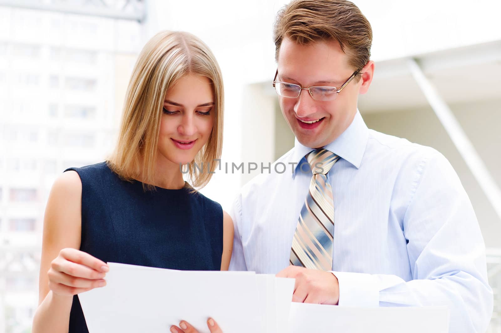 business man and business woman in the office to discuss reports by adam121