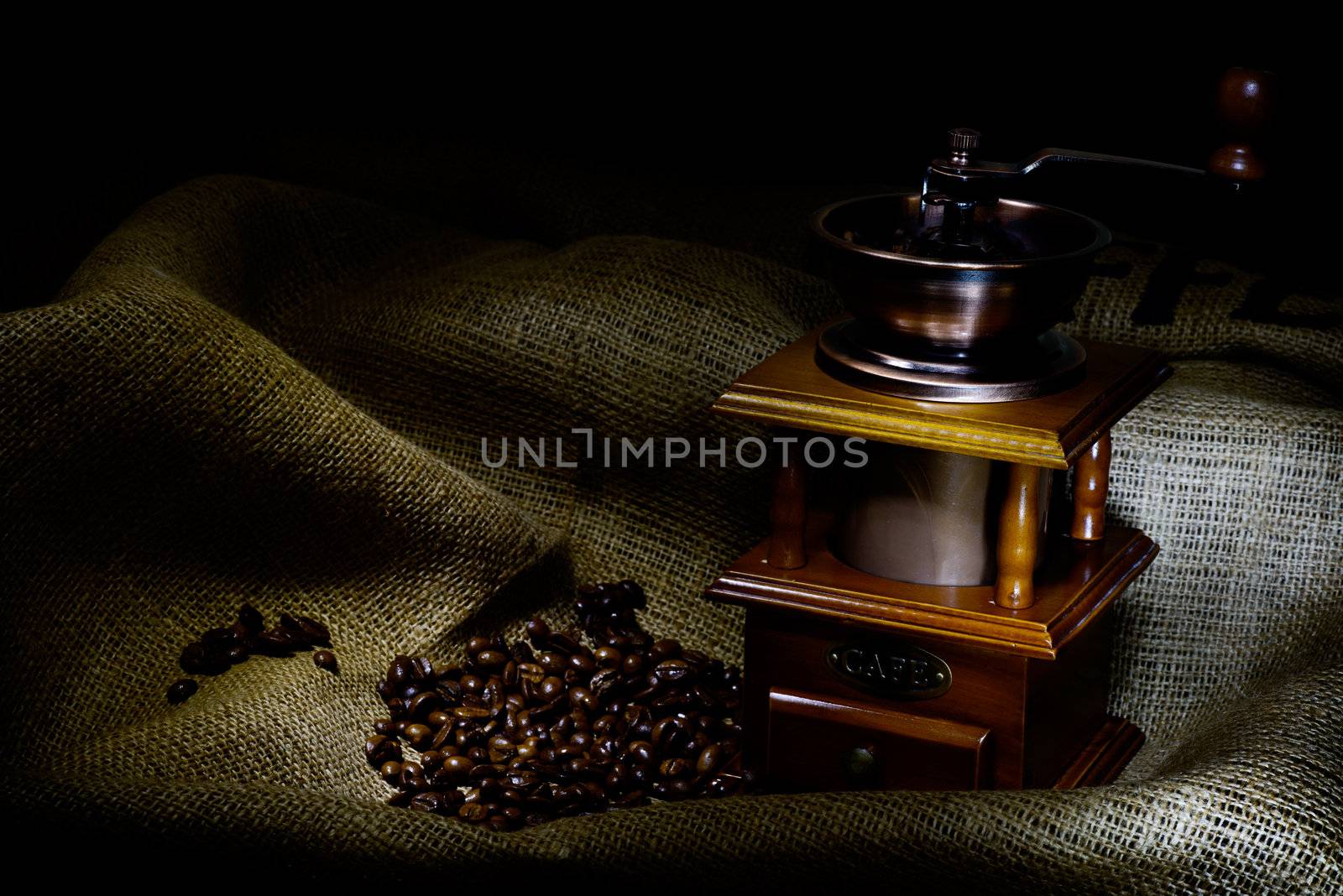Coffee Mill with beans and burlap, emphasis rays of light