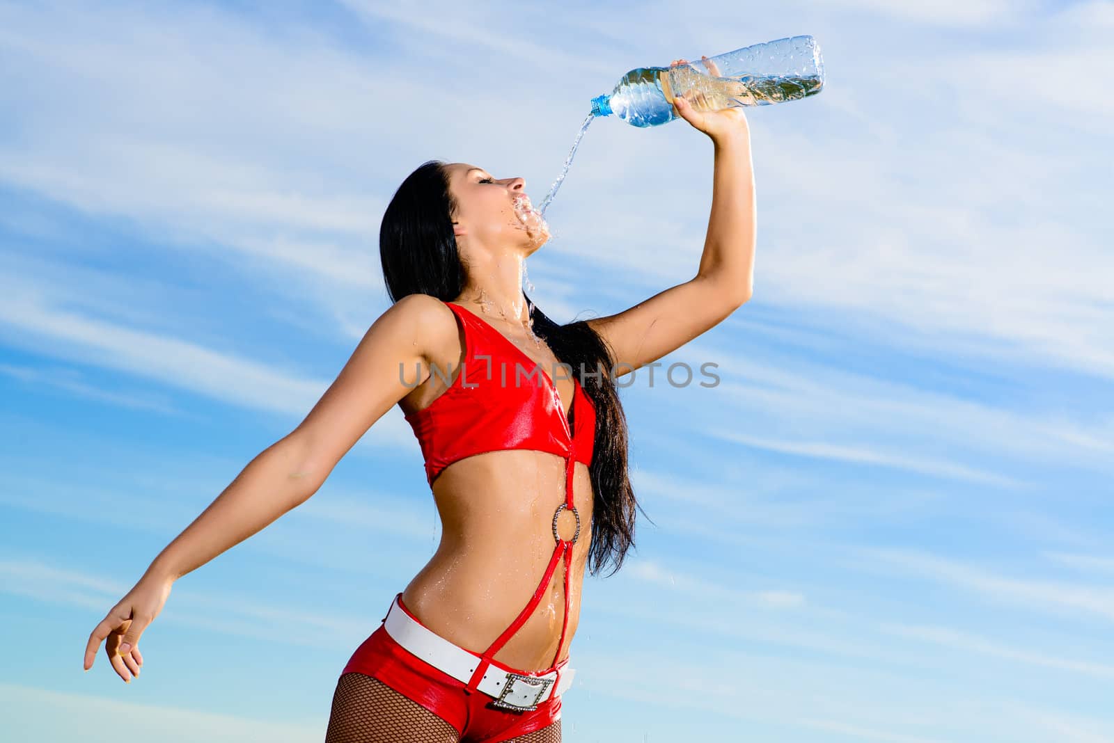 sport girl in red uniform with a bottle of water by adam121