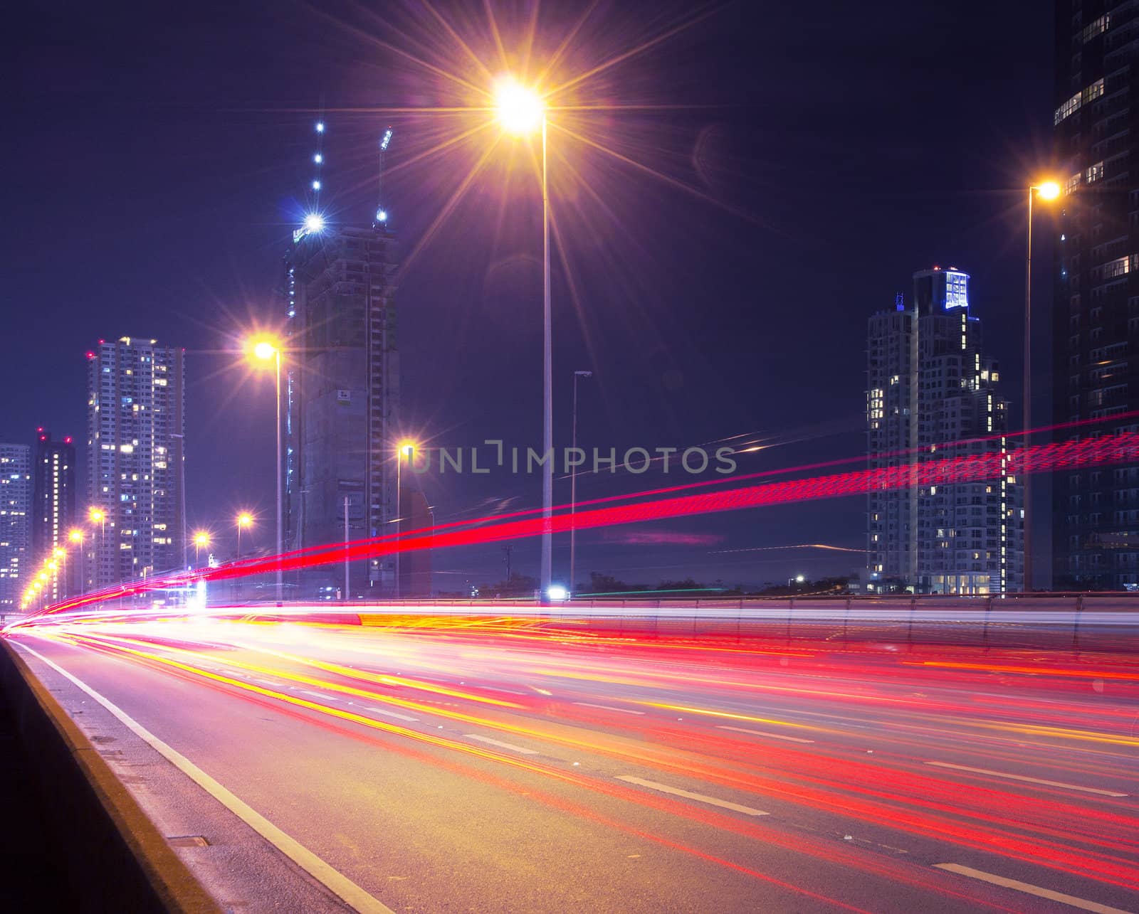 Light in car on city streets at night in Bangkok, Thailand.