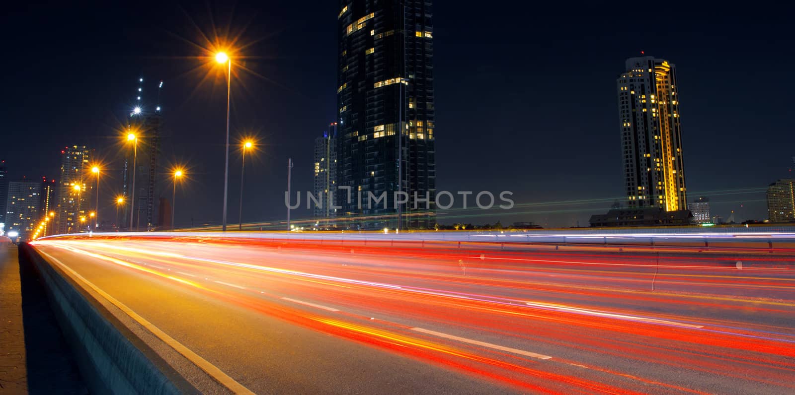 Light in car on city streets at night in Bangkok, Thailand.