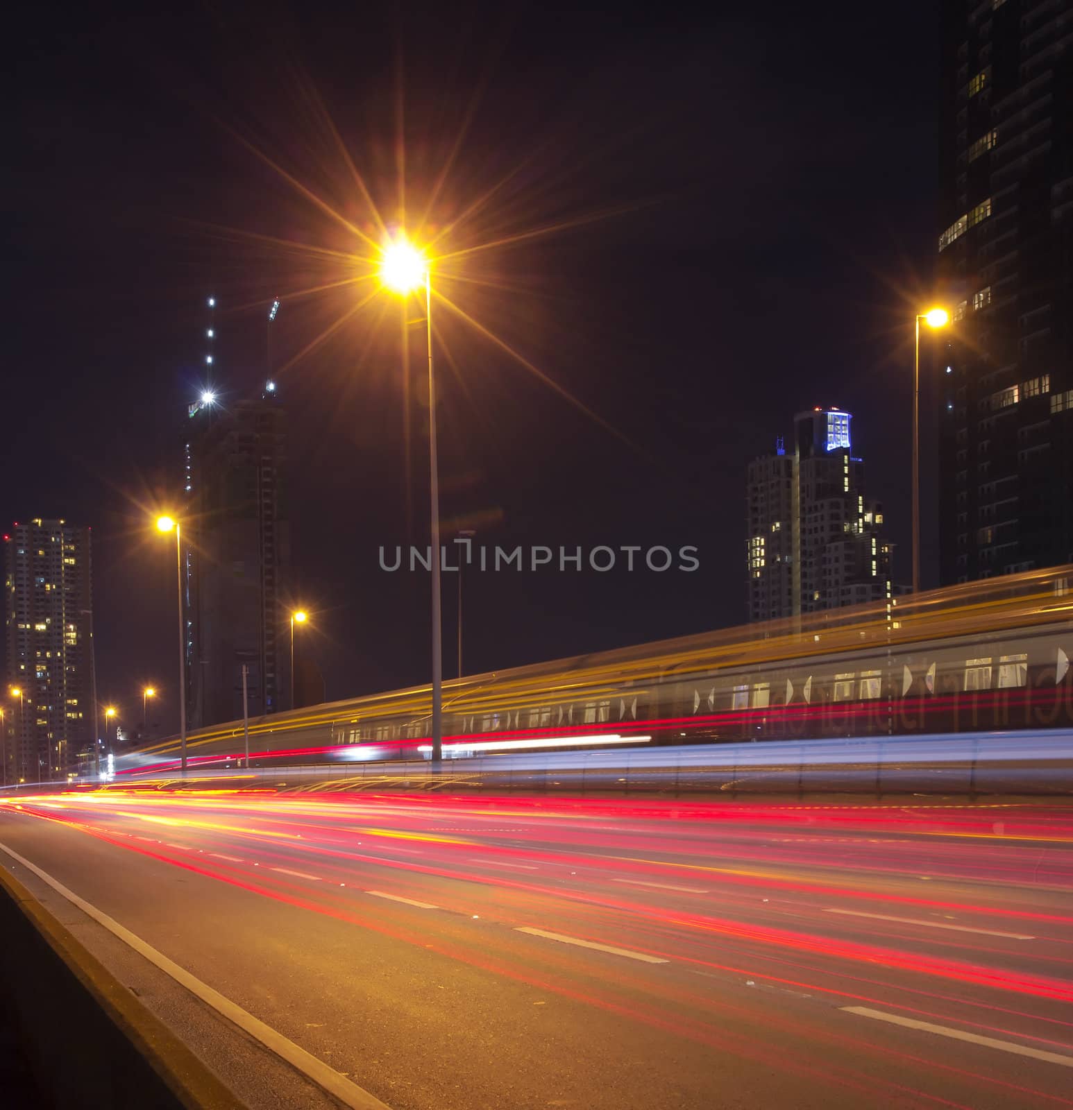 Light in car on city streets at night in Bangkok, Thailand.