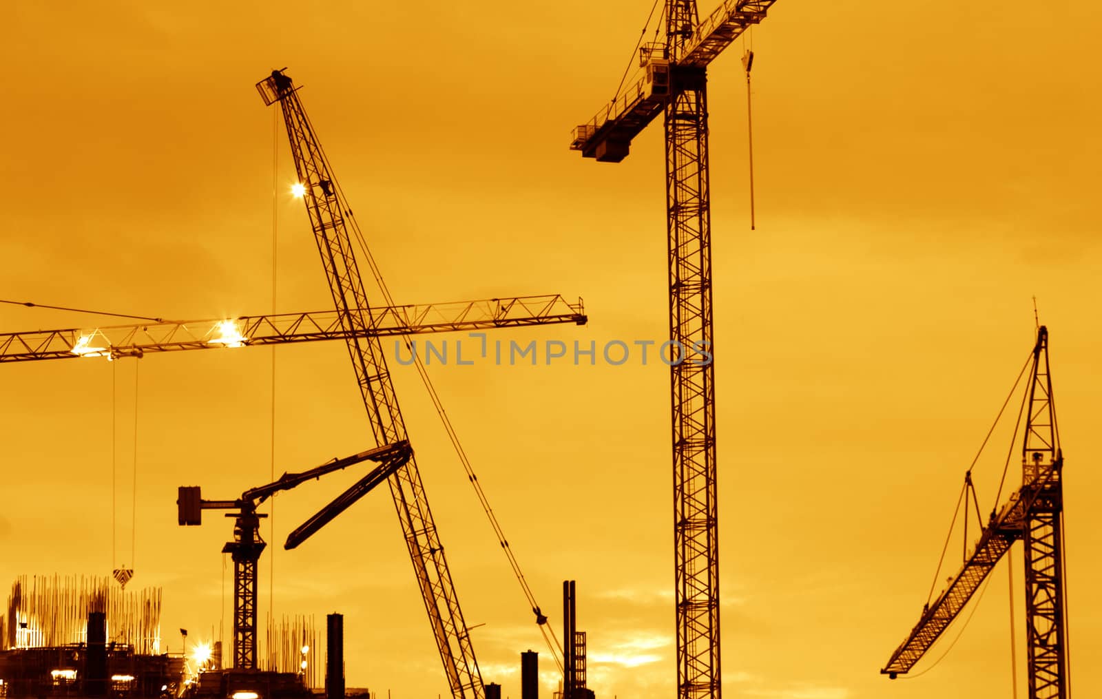 Building Construction with Cranes in the evening.