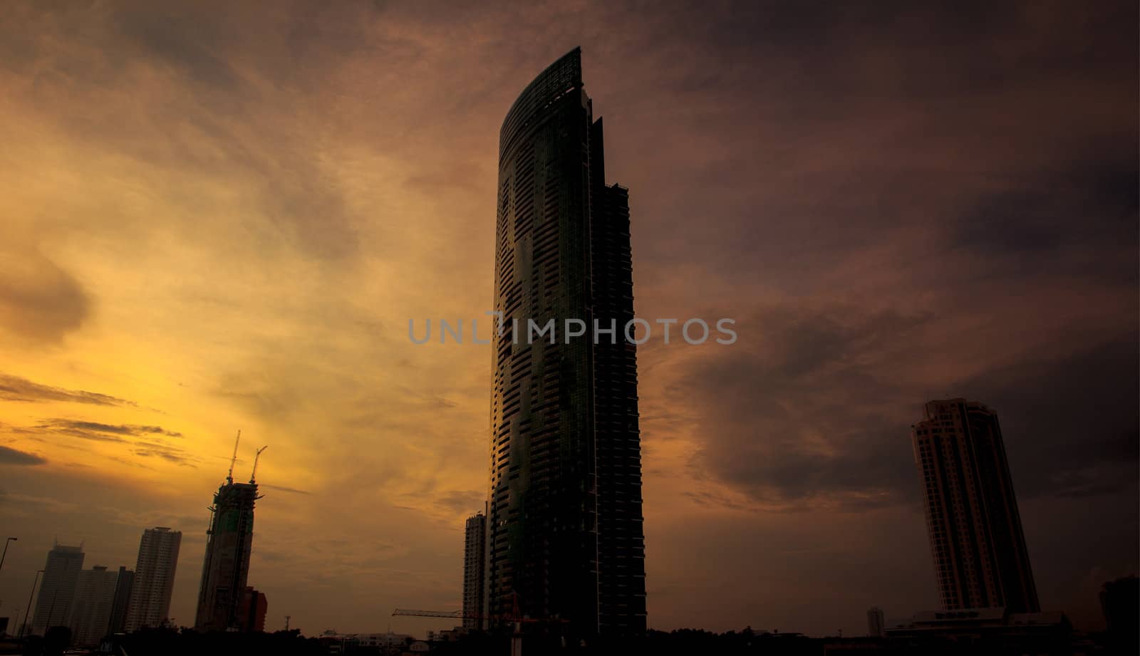 Modern skyscrapers in the evening with orange light in Bangkok Thailand.