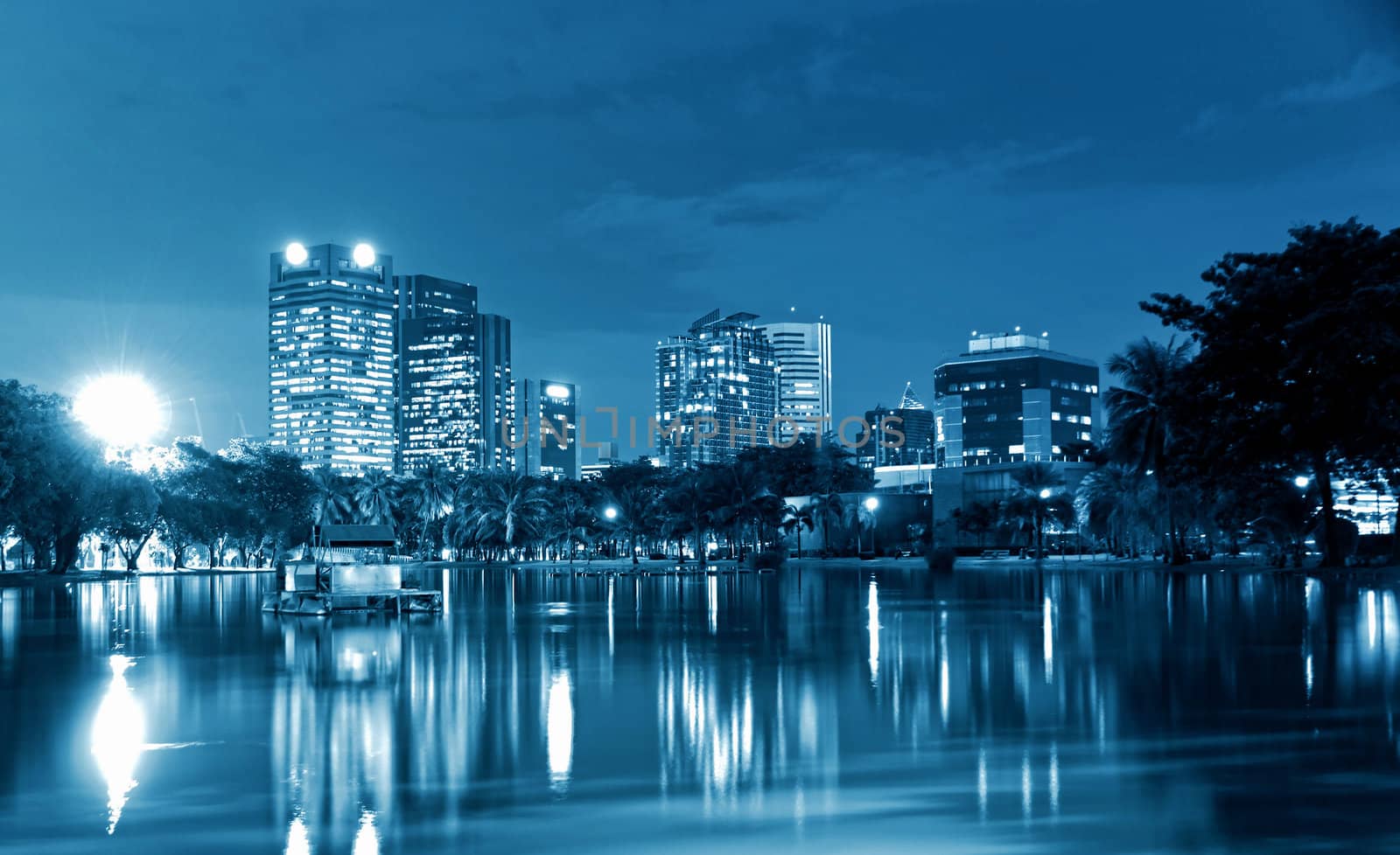 City at night, panoramic scene of downtown reflected in water,thailand