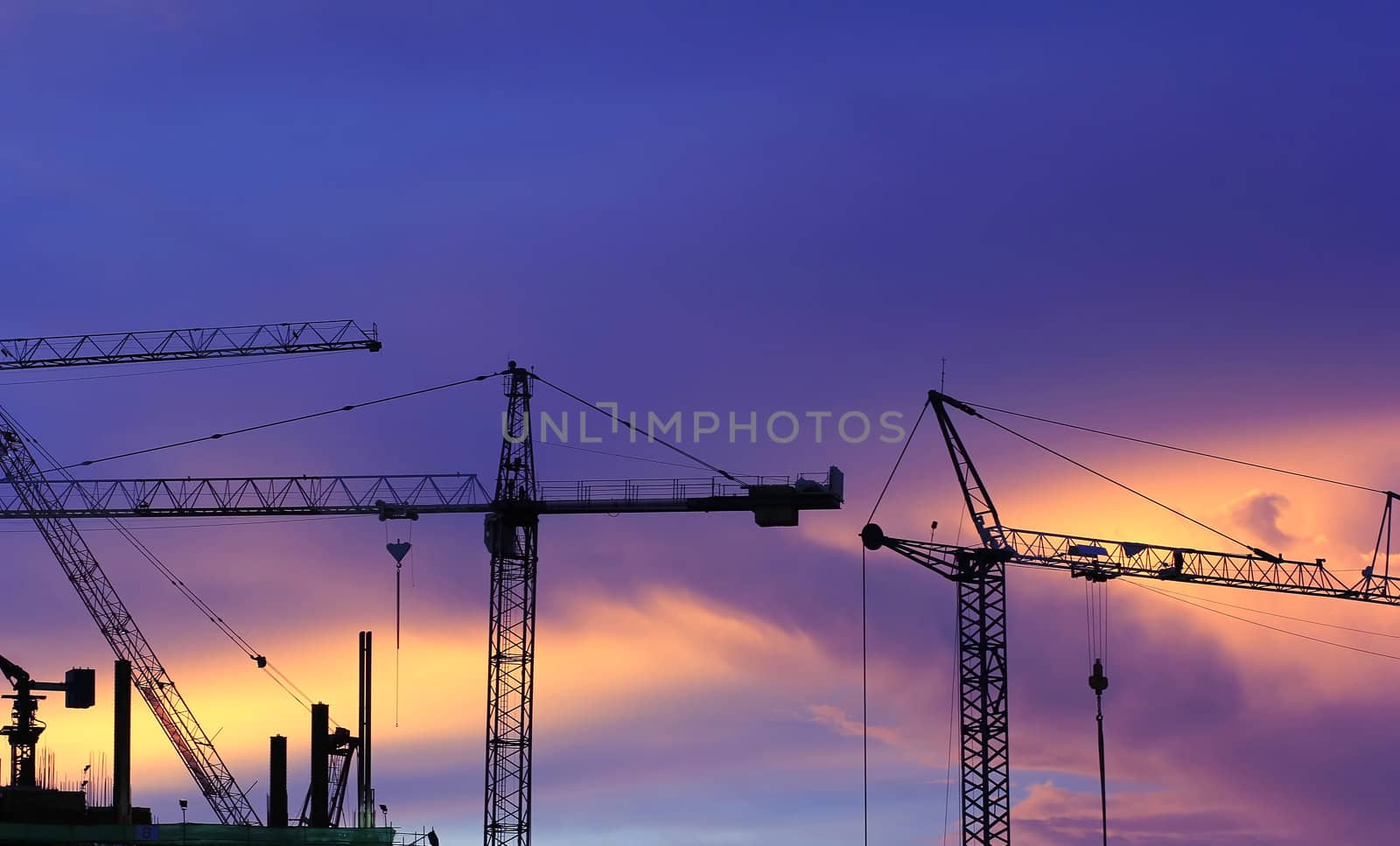 Construction work. Tower cranes are used to complete the task quickly.