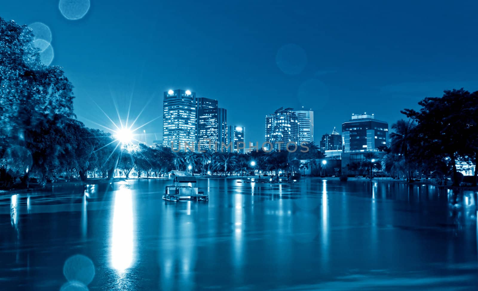 City at night, panoramic scene of downtown reflected in water,thailand