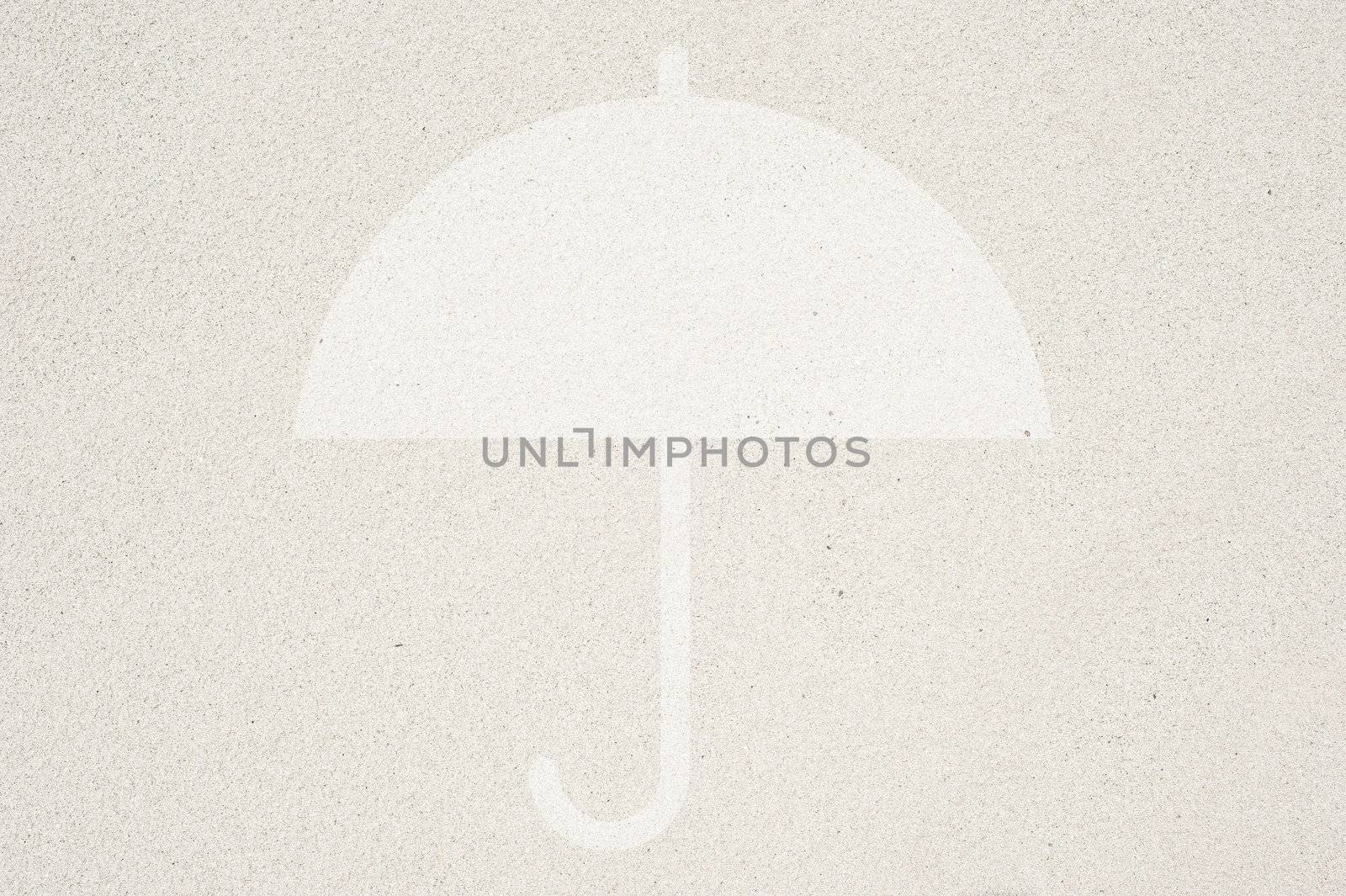 Umbrella icon on sand background and textured 