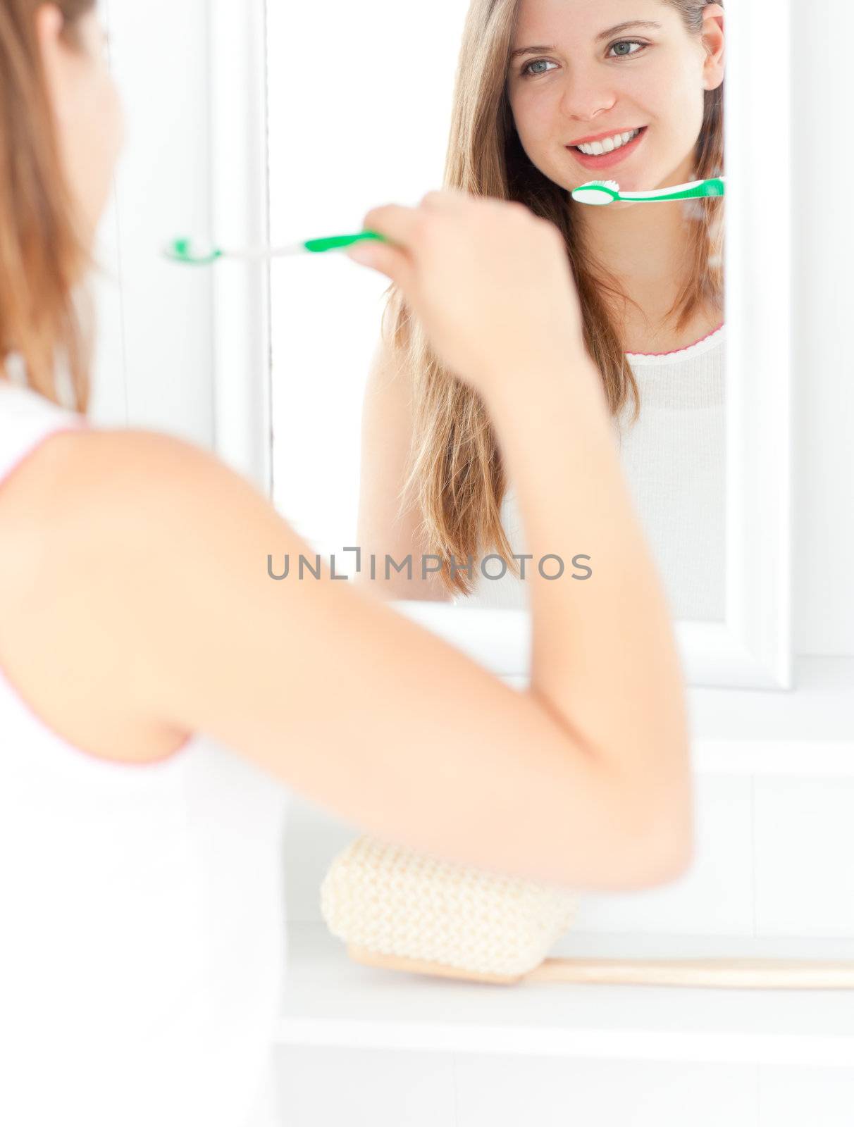 Captivating caucasian woman holding a toothbrush in the bathroom