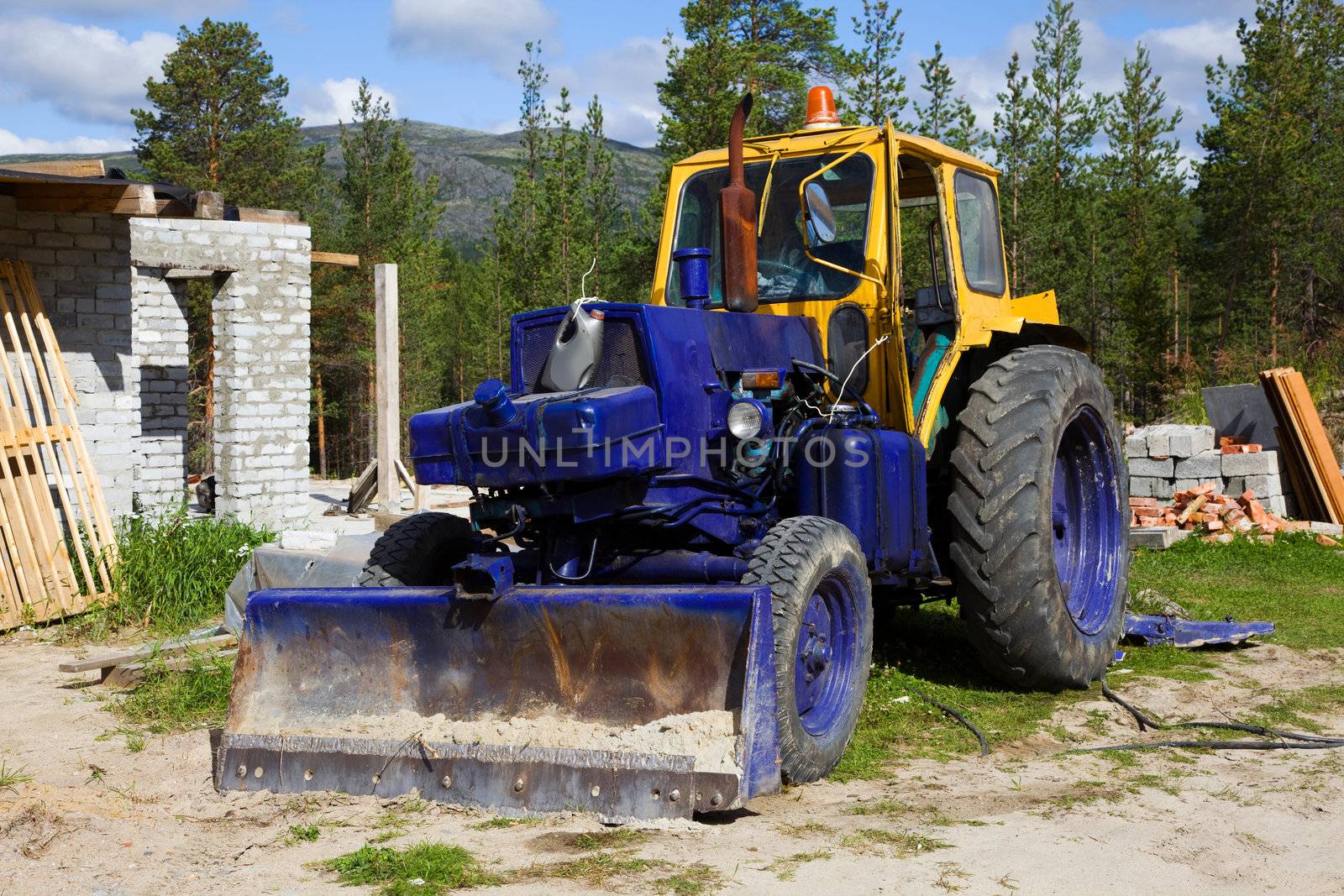 Old  tractor on a construction site. summer