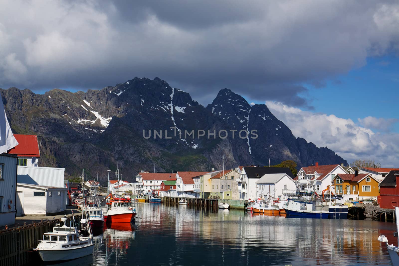 Colorful fishing harbor on Lofoten Islands in Norway with mountains towering in the background