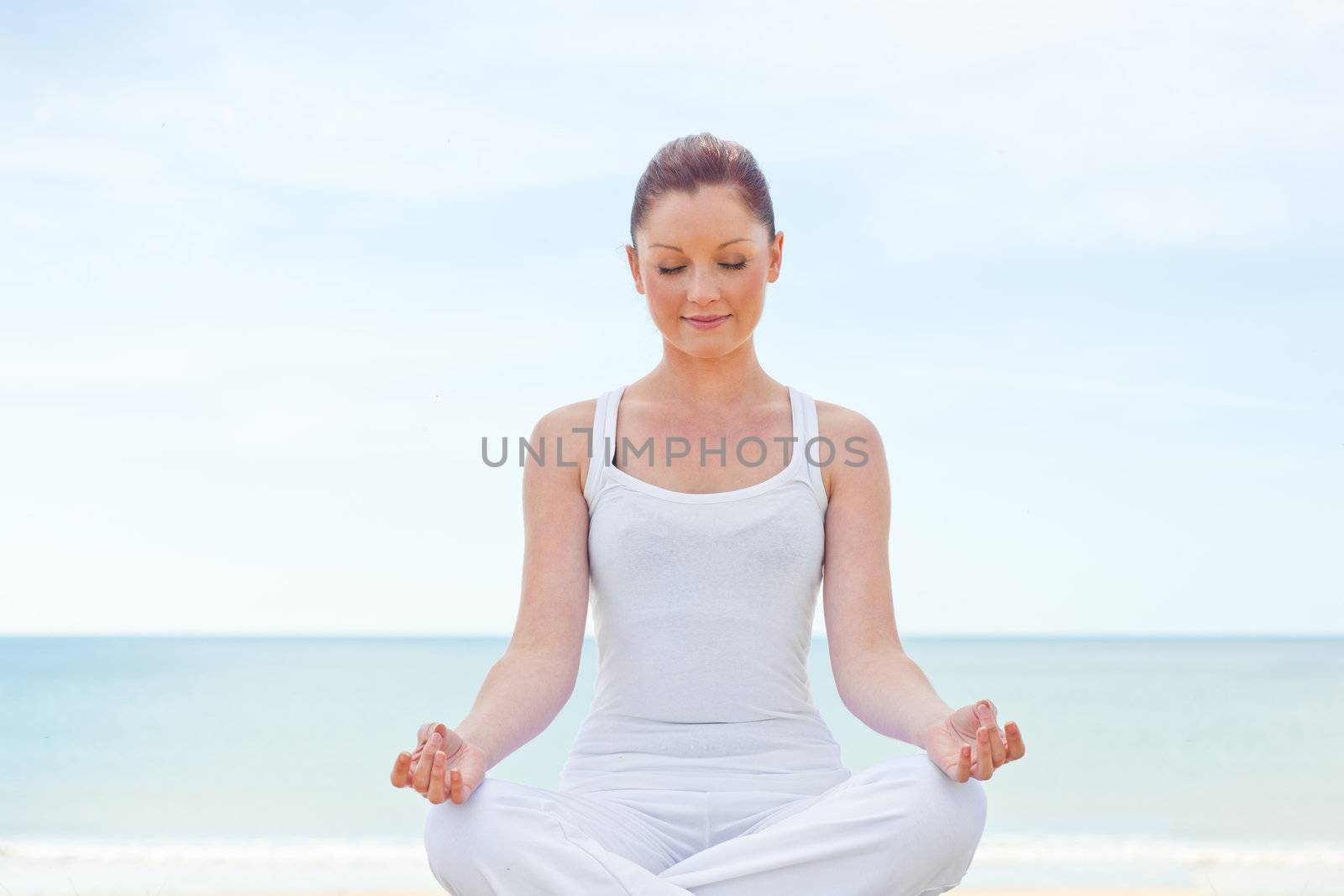 Caucasian healthy woman doing yoga on beach  by Wavebreakmedia