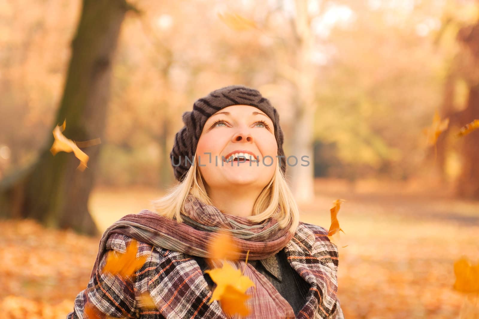 Young woman enjoying sunny day in autumn in the park