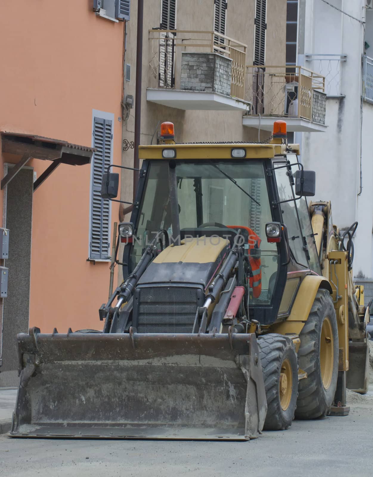 Big scraper parked on the side of the road