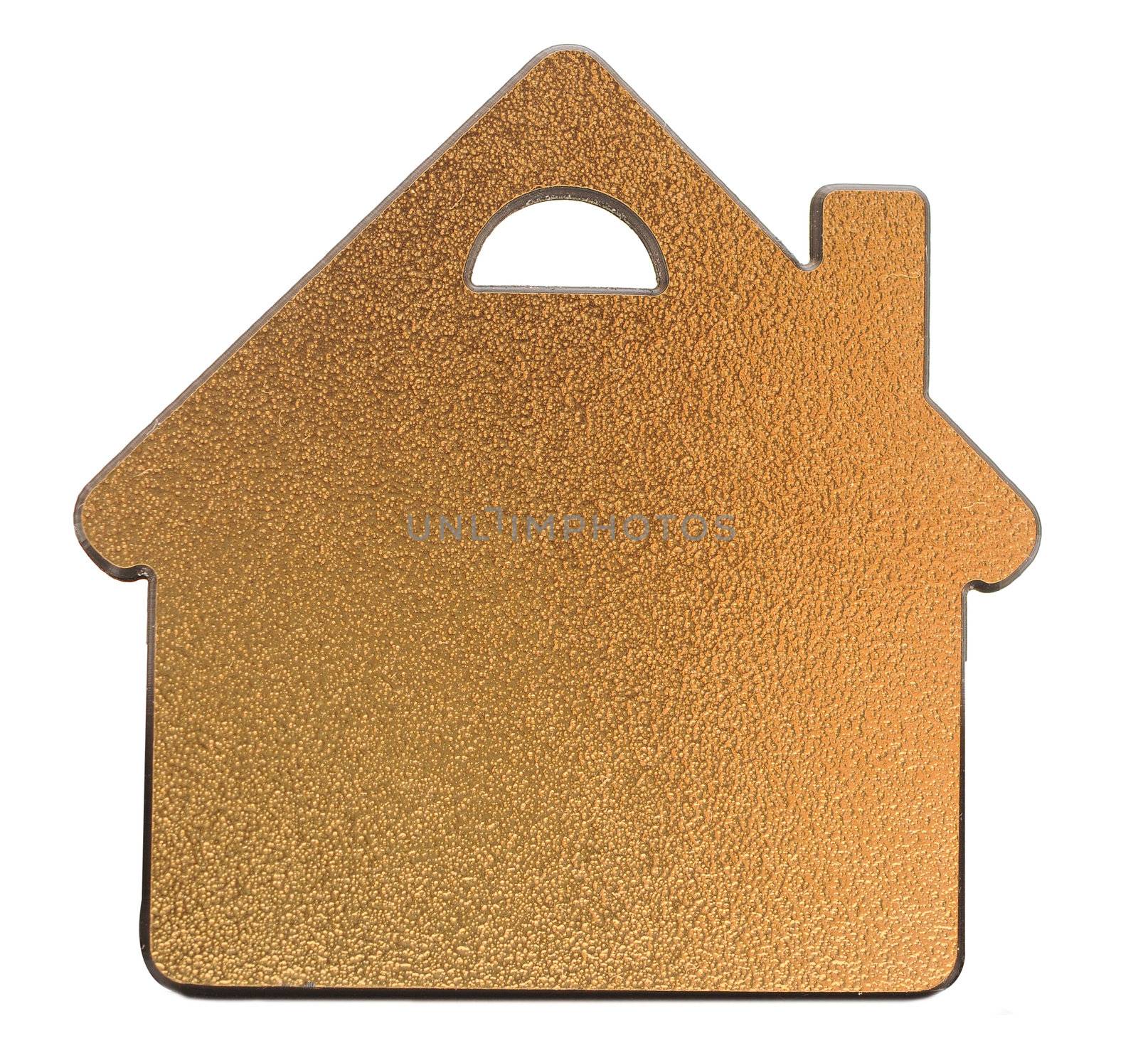 golden metallic house shaped object on white background 