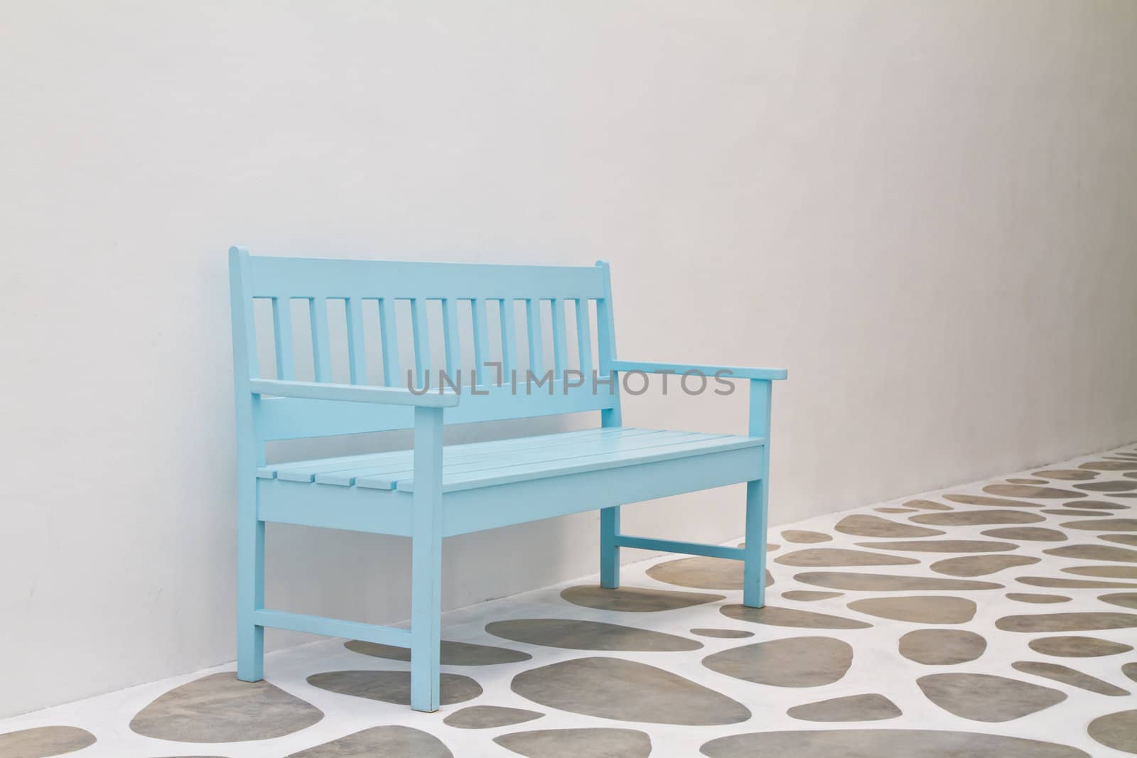 Blue chair on path walk and white wall
