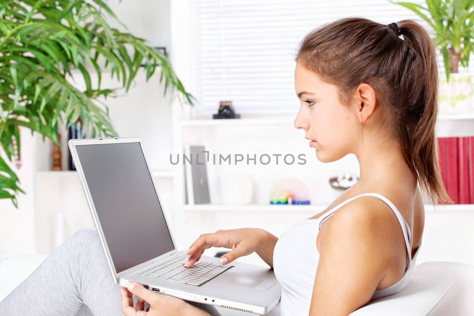 woman working on laptop at home by imarin
