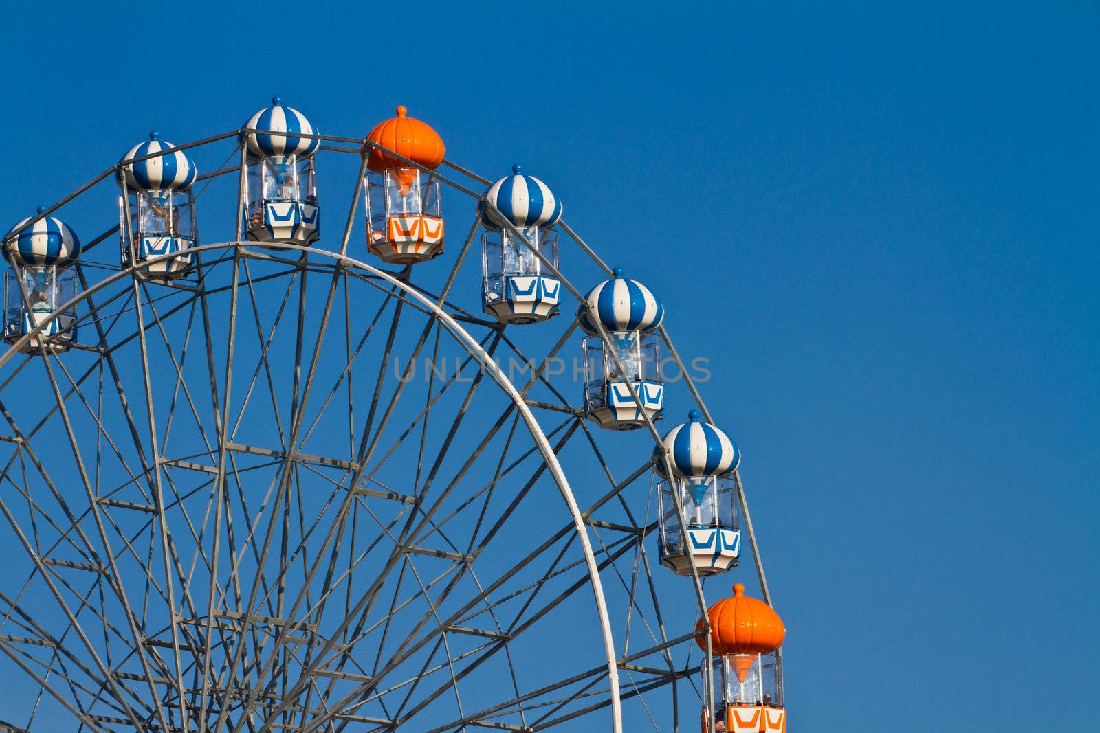 Colorful ferris wheel on the blue sky