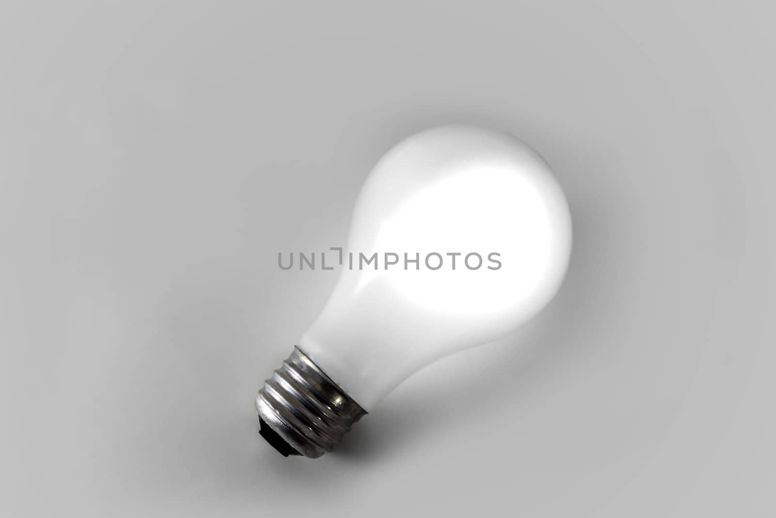 White Incandescent Light Bulb Isolated on White Backdrop