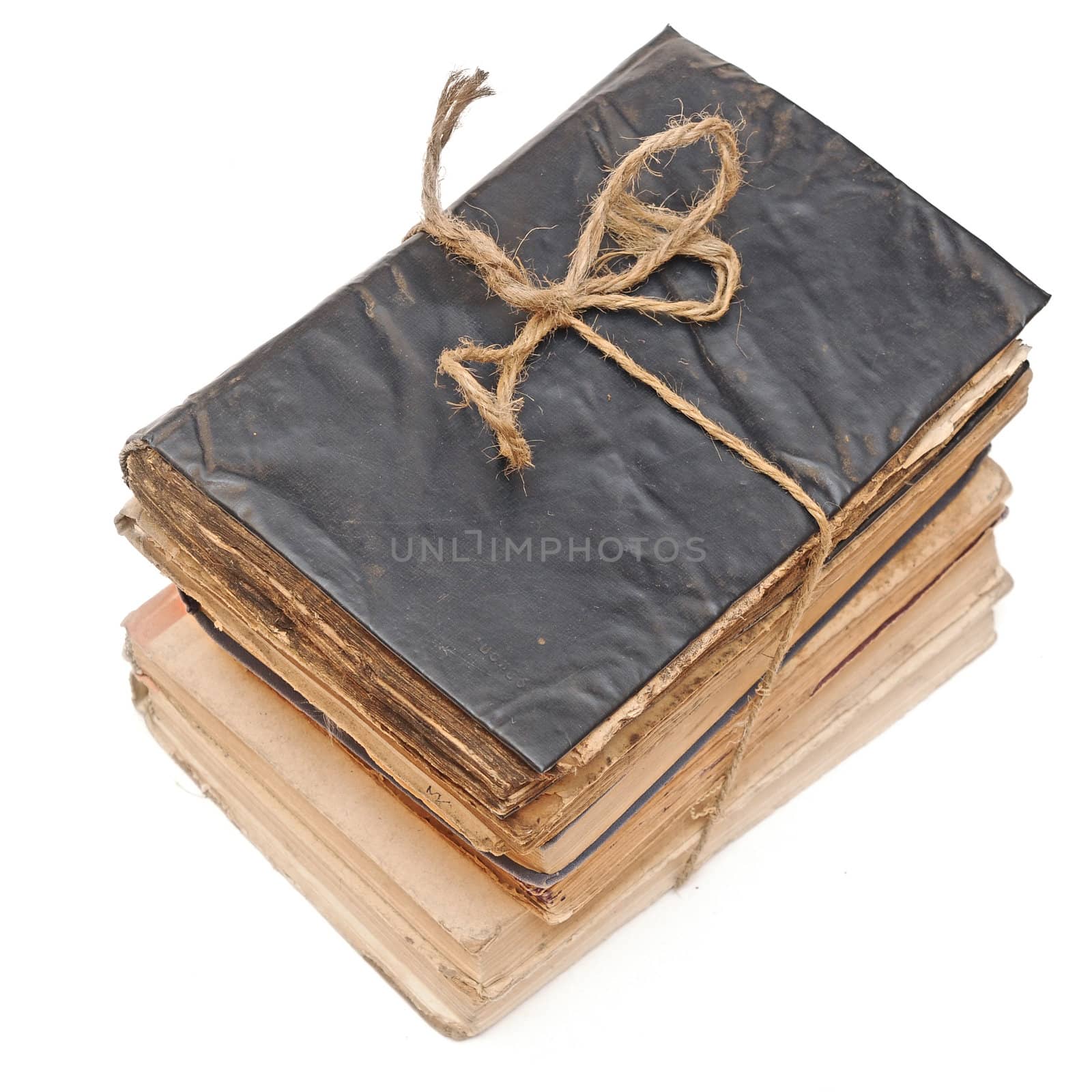 Stack of old books tied with rope isolated on white 