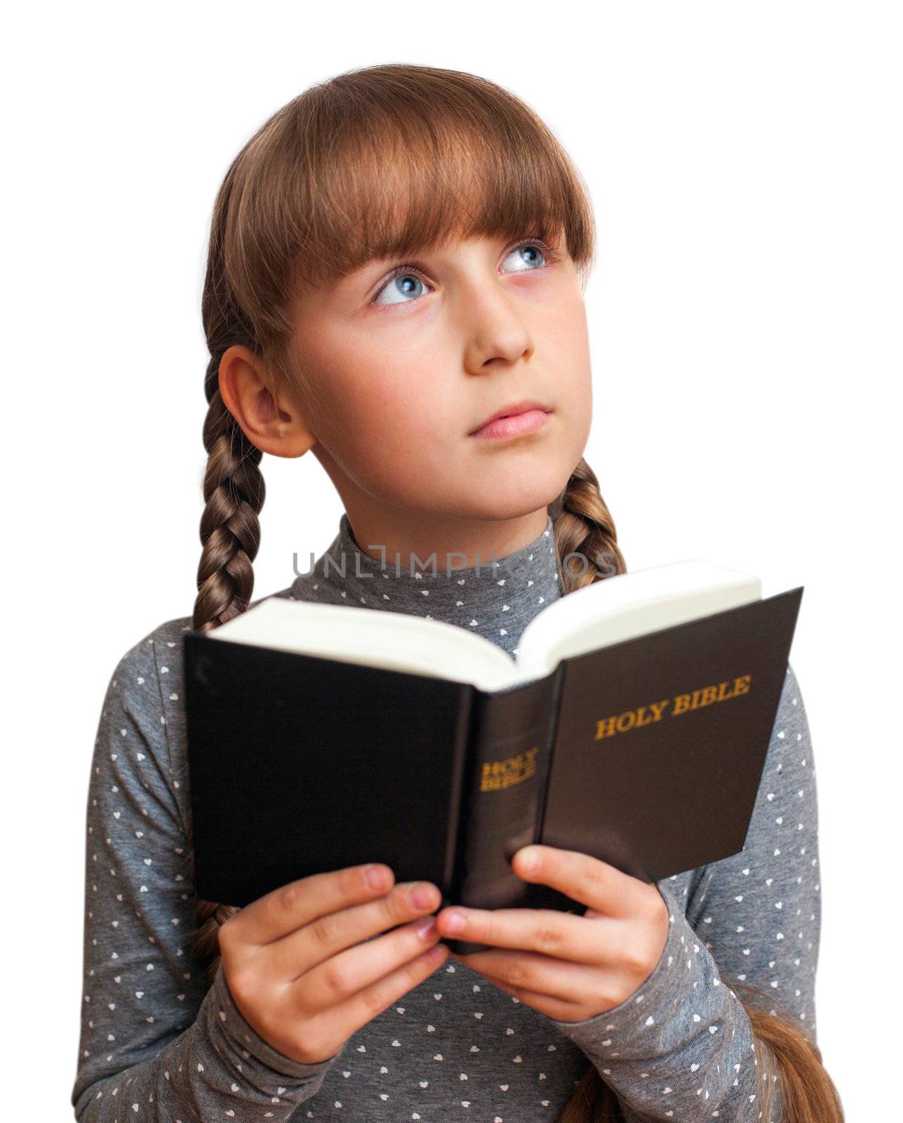 girl reading a book in the Bible and thinks