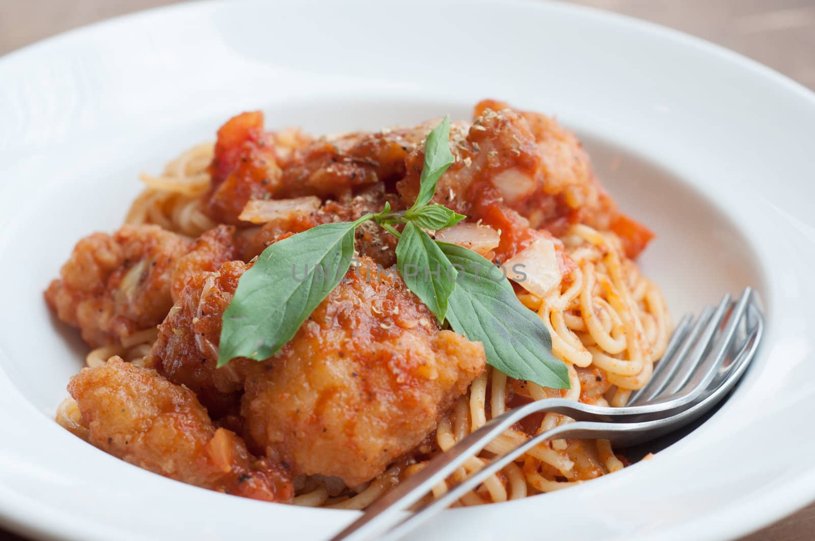 spaghetti with spicy fried fish on sauce