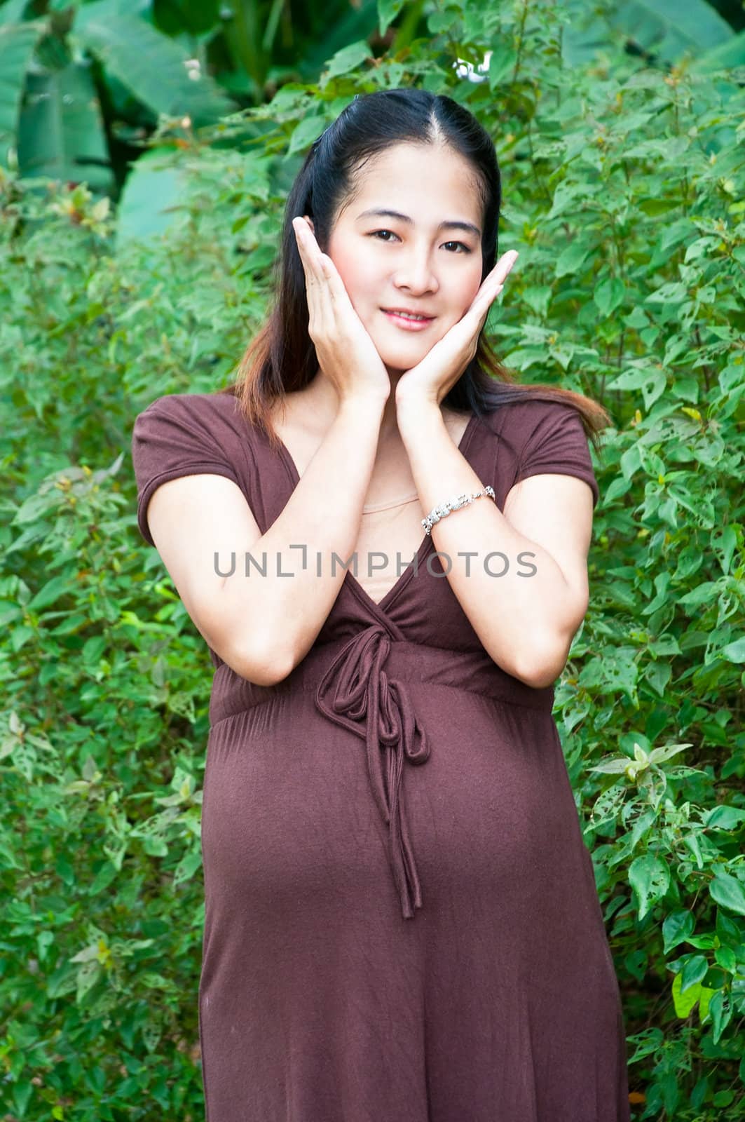 Beautiful pregnant woman relaxing in the park