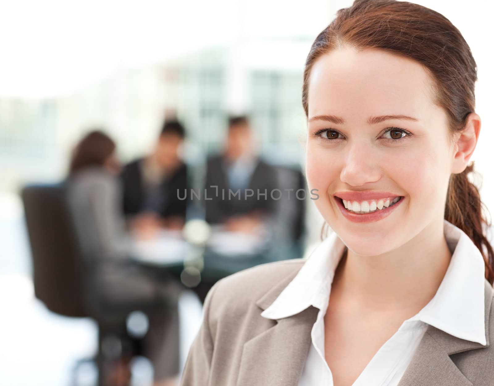 Cheerful businesswoman during a meeting with her team at the office