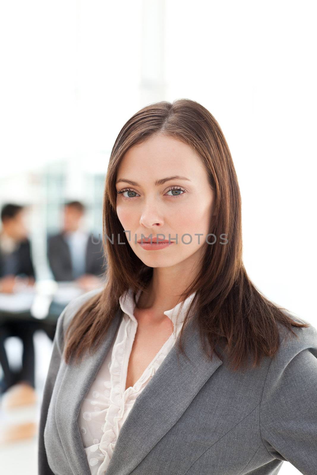 Serious businesswoman during a meeting with two businessmen by Wavebreakmedia