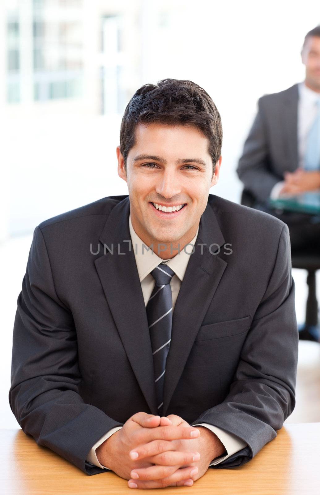 Happy businessman during an interview with a colleague at the office