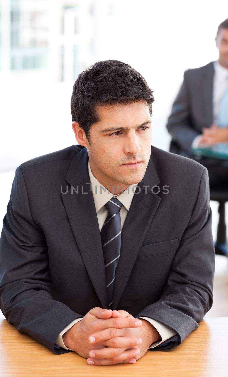 Thoughtful businessman during a meeting with a colleague at the office