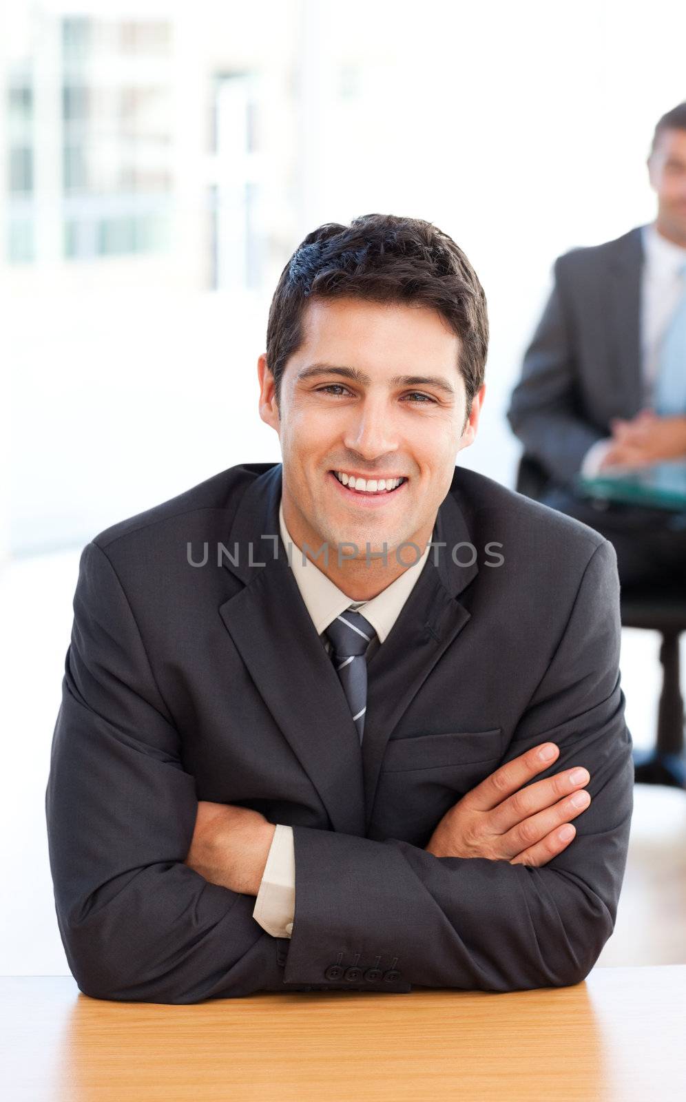 Delighted businessman in the foreground during a meeting with a  by Wavebreakmedia