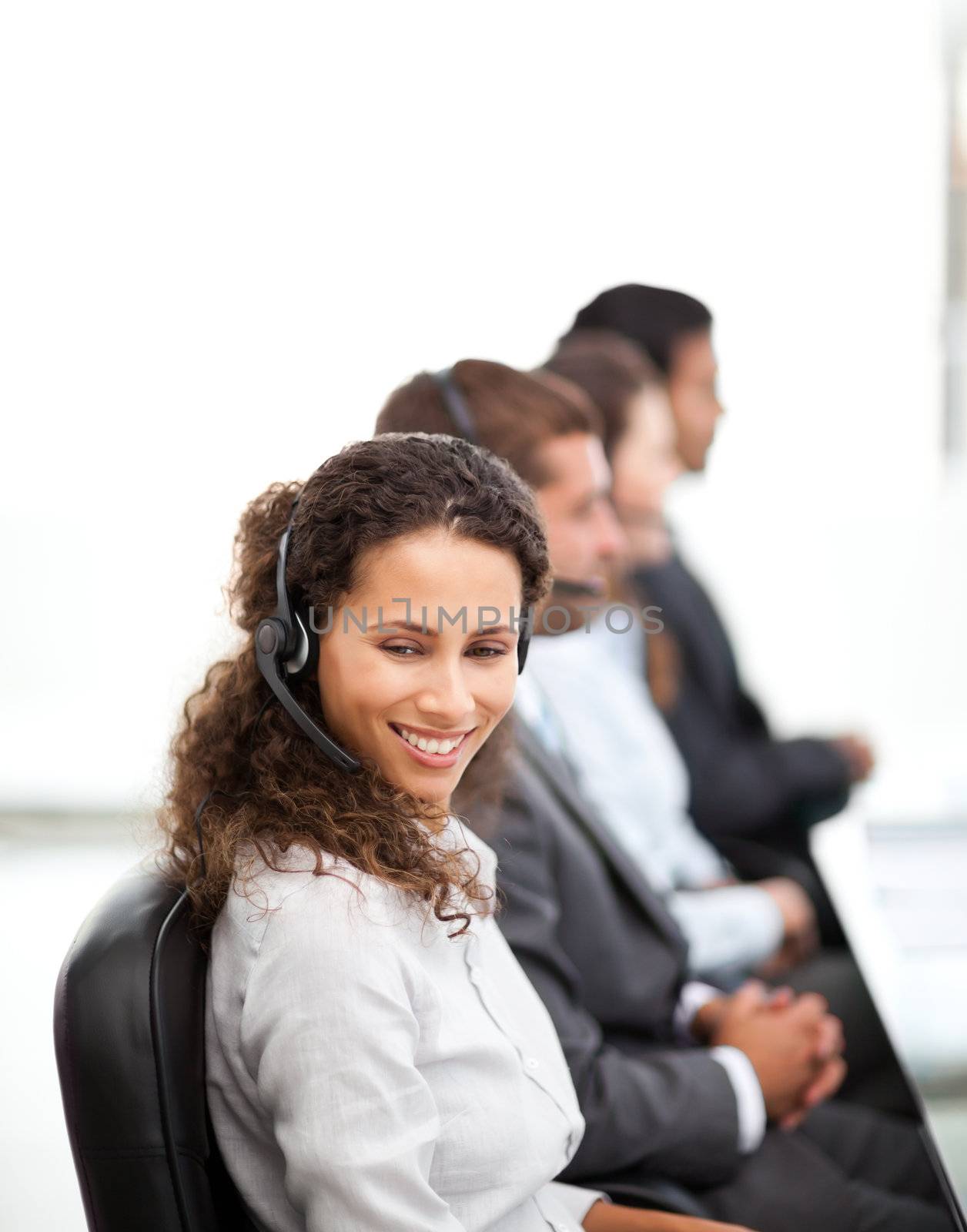 Happy representative with her colleagues working in a call center together