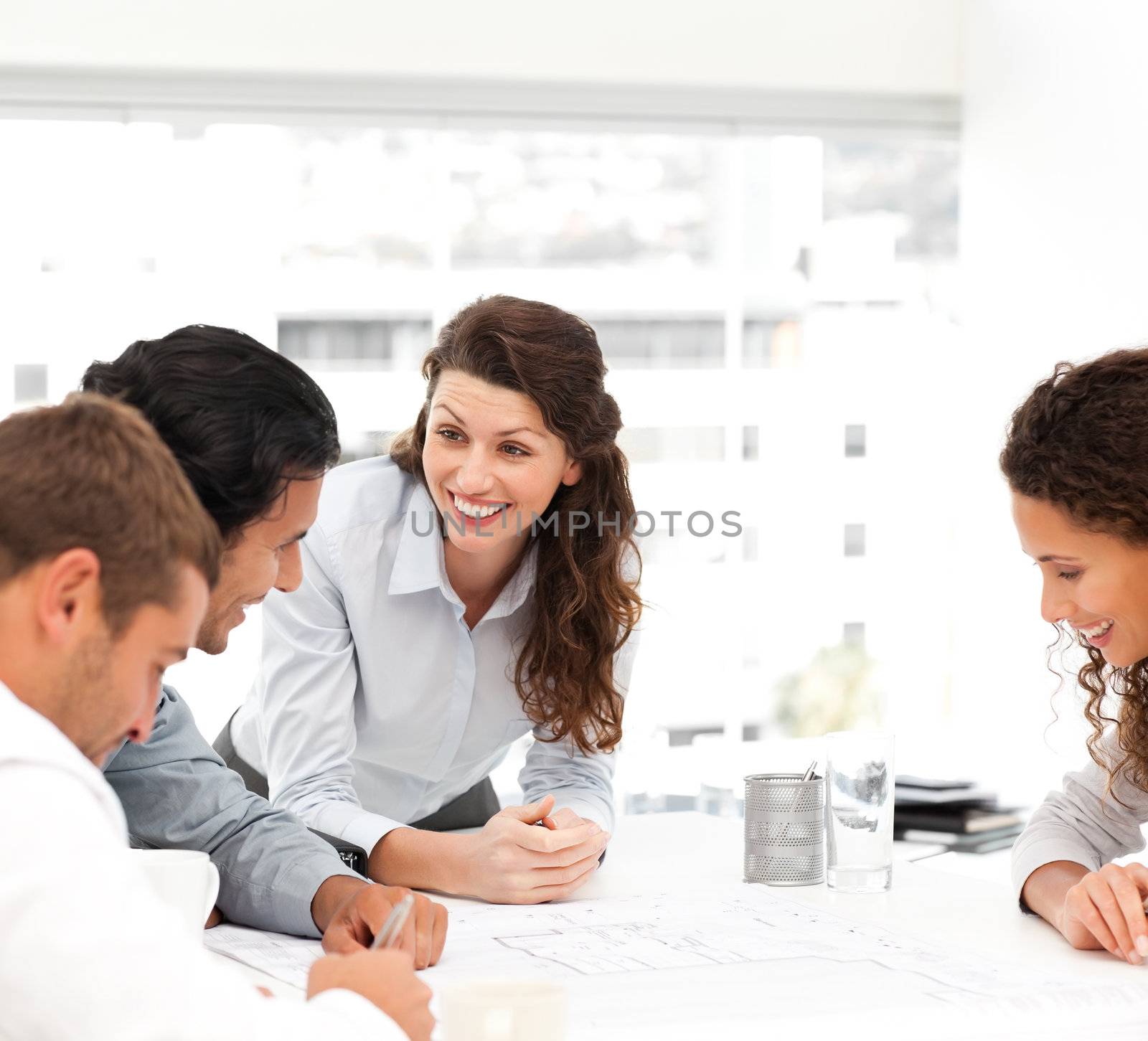 Happy female architect with her team during a meeting  by Wavebreakmedia