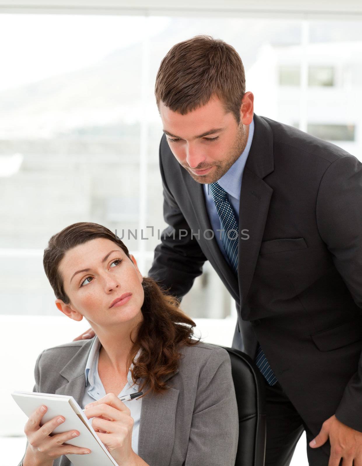Handsome manager talking with her secretary in the office  by Wavebreakmedia