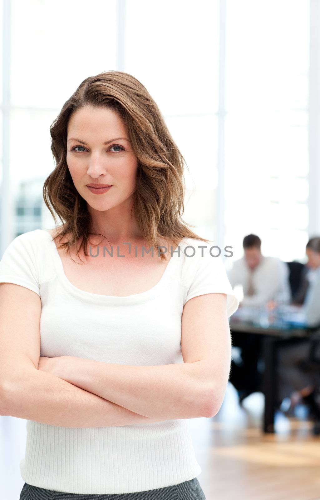 Proud businesswoman standing in front of her team while working by Wavebreakmedia
