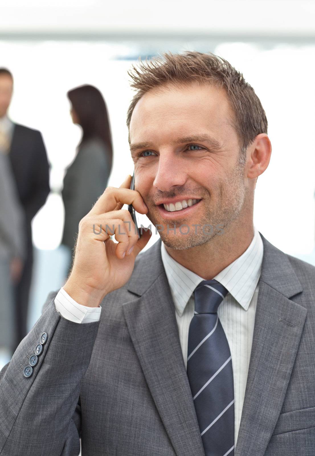 Successful businessman on the phone during a meeting by Wavebreakmedia