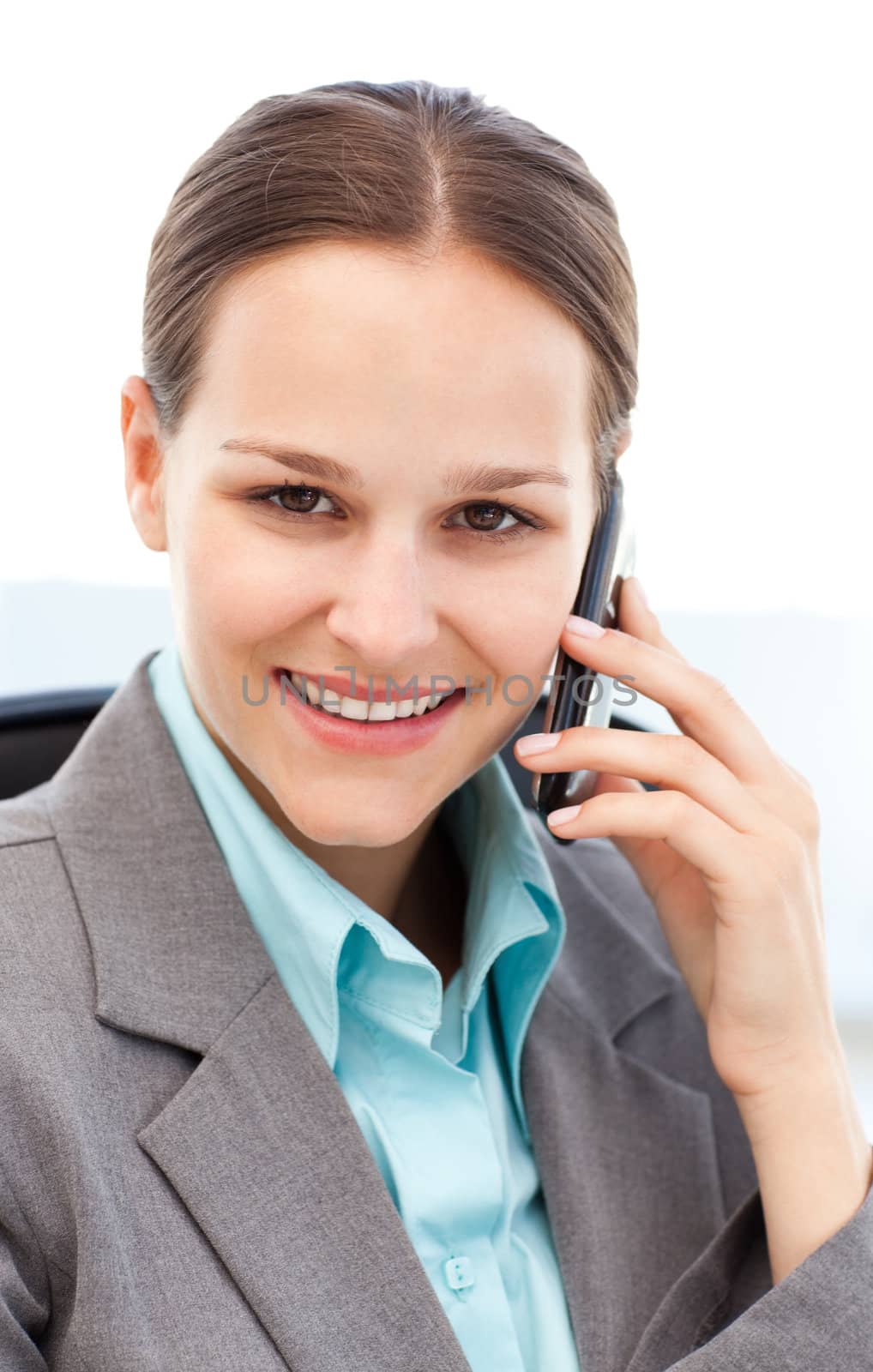 Portrait of a young businesswoman on the phone with her cellphone at work