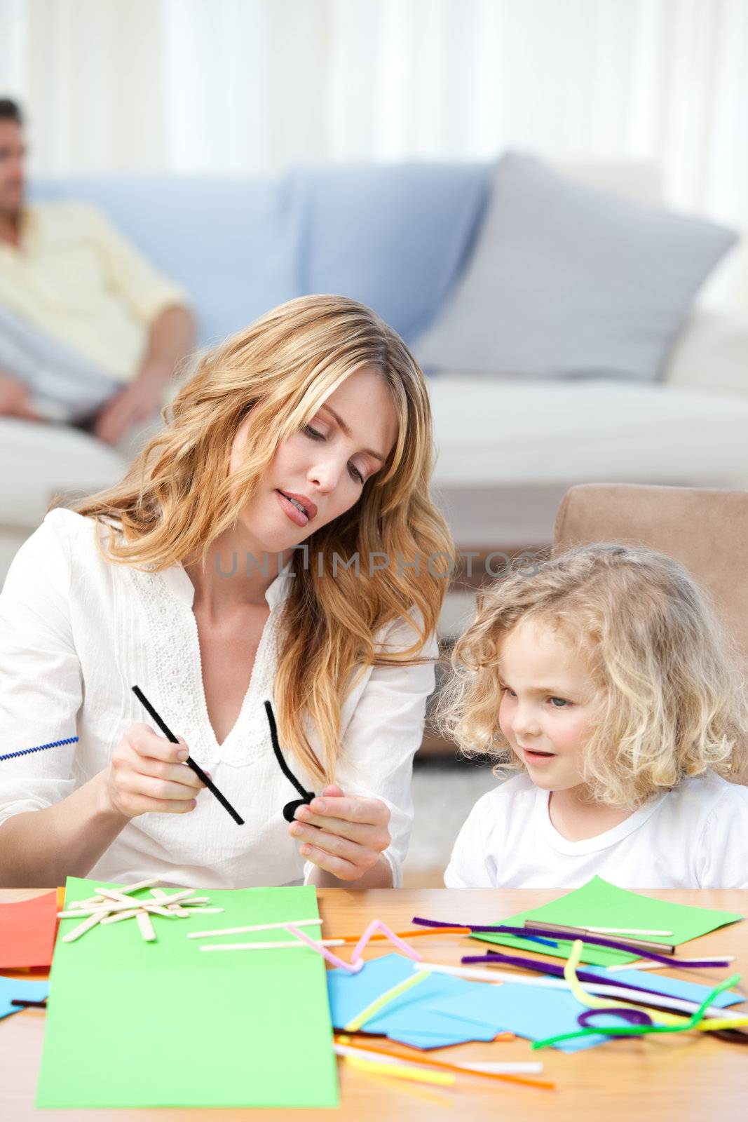 Woman and  her daughter cutting paper by Wavebreakmedia