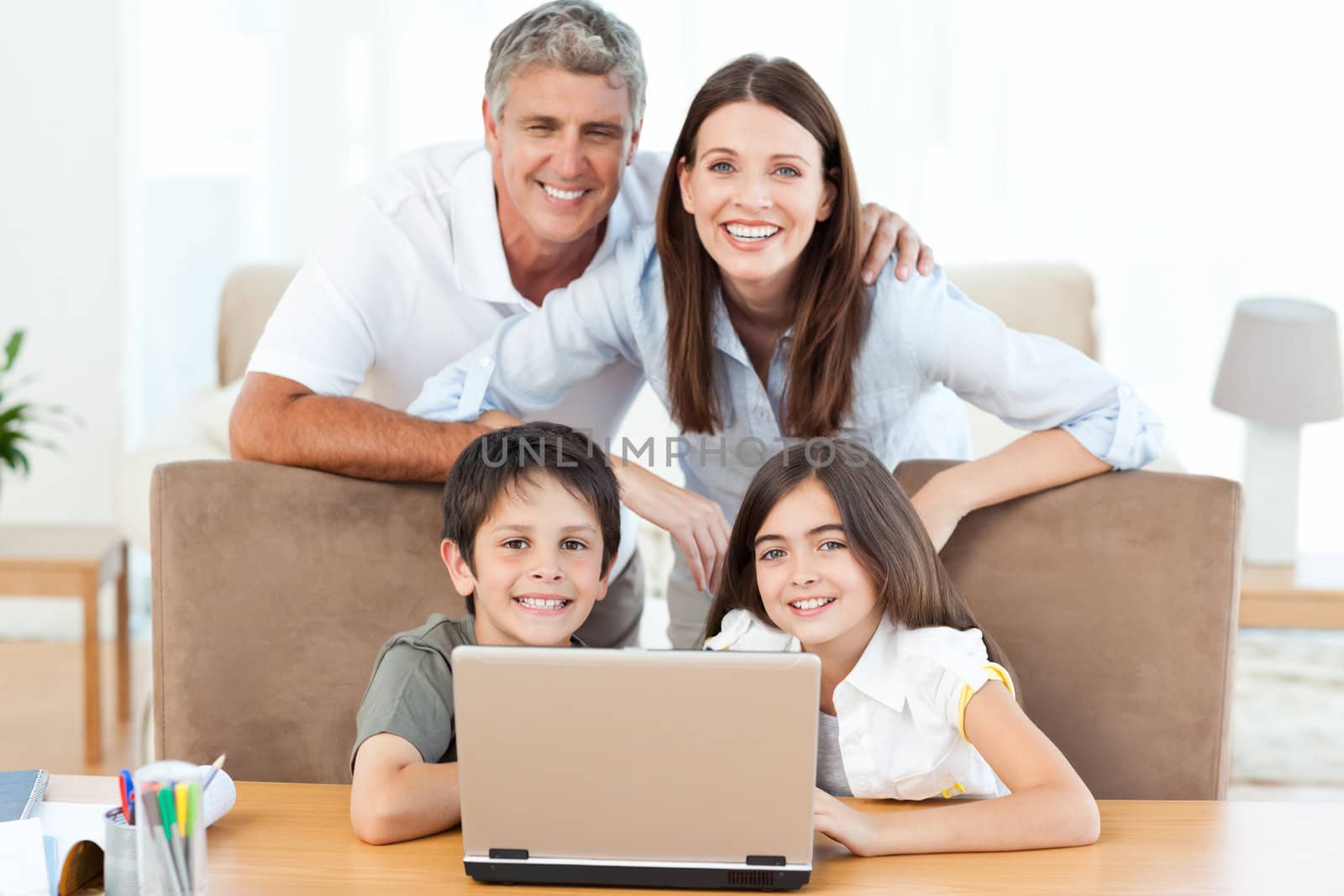 Joyful family looking at the camera at home