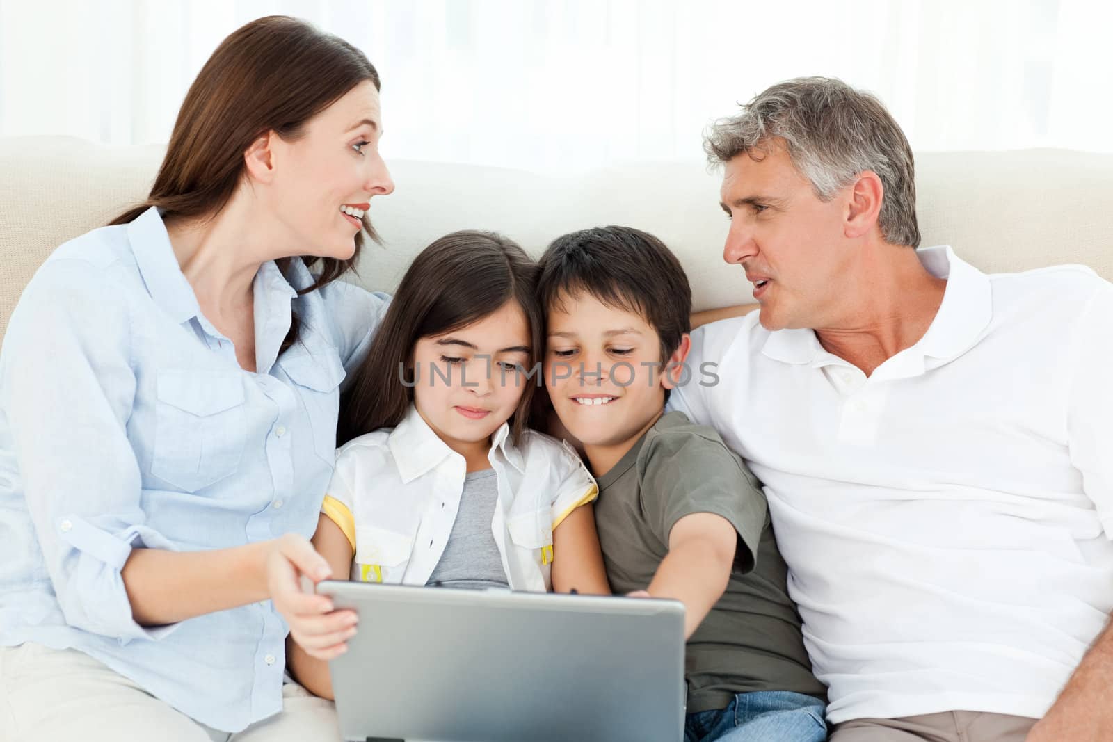 Family looking at  the laptop at home