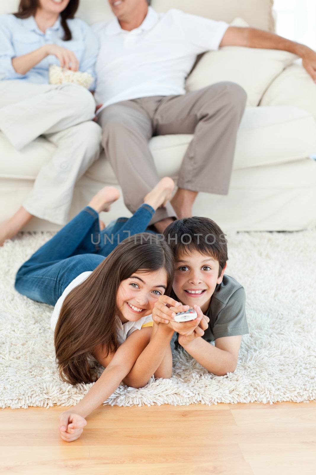 Family watching tv in the living room by Wavebreakmedia