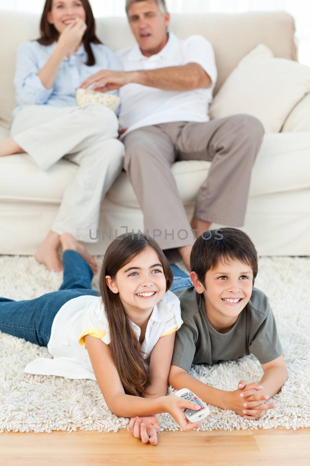 Family watching tv in the living room at home