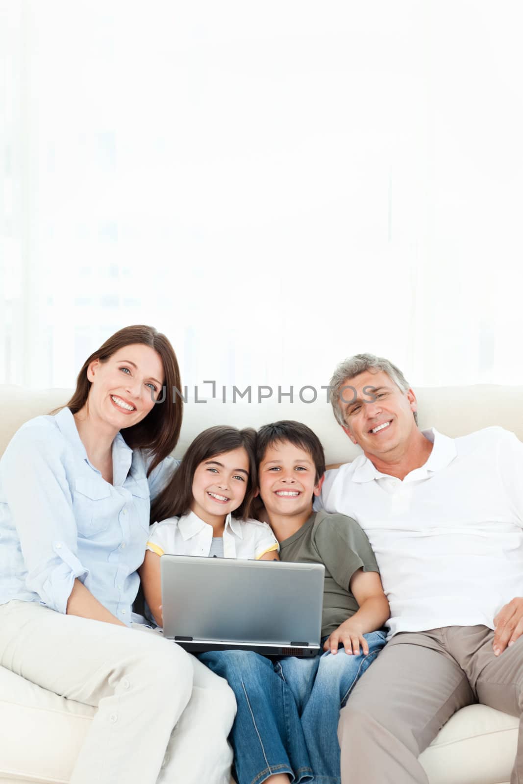 Pretty family looking at the camera at home by Wavebreakmedia