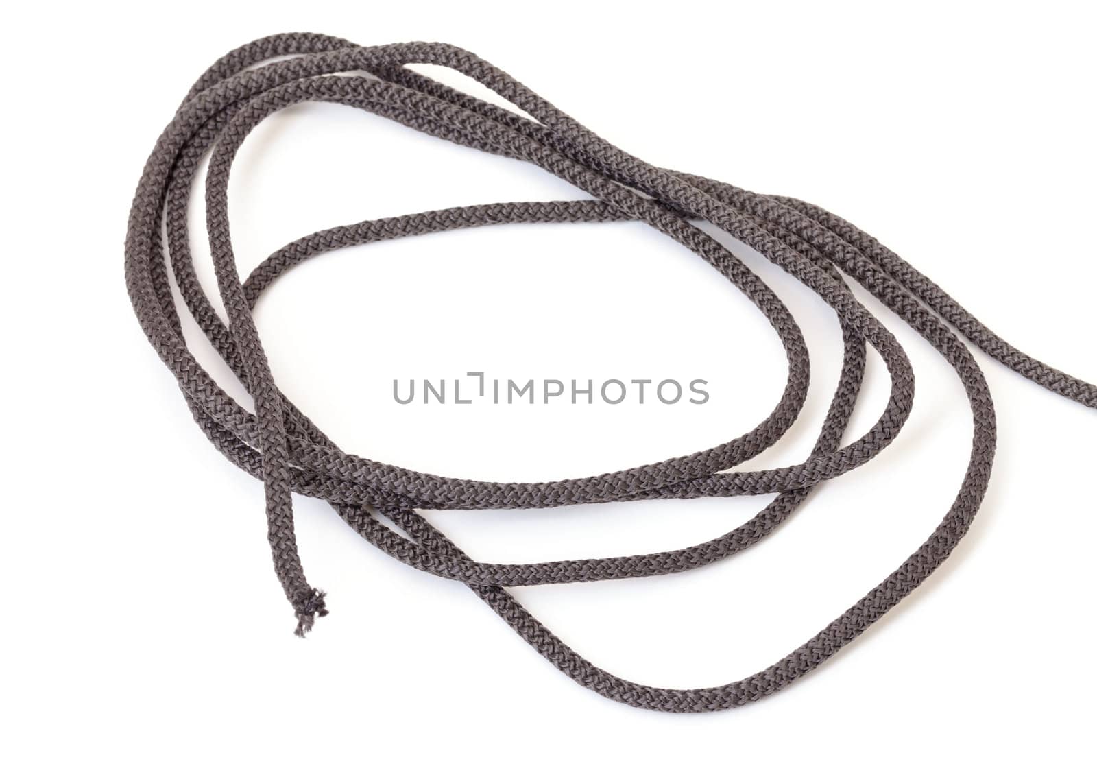 Roll of braided interwoven dark cord found in every household for general tying, securing and attachment of articles on a white background