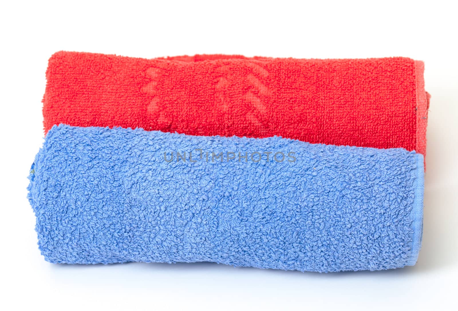 Rolled red and blue towels by Discovod