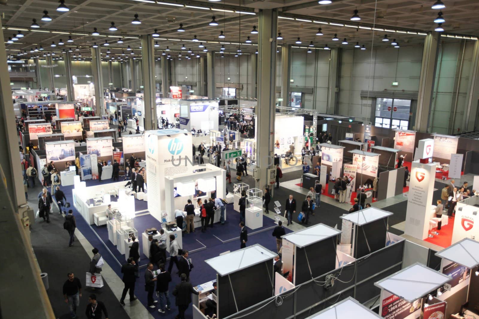 MILAN, ITALY - OCTOBER 17: People visit technologies products exhibition area at SMAU, international fair of business intelligence and information technology October 17, 2012 in Milan, Italy.